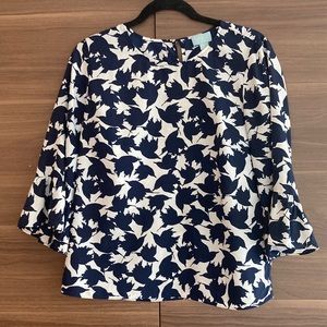 CeCe navy and white blouse with ruffle sleeves.